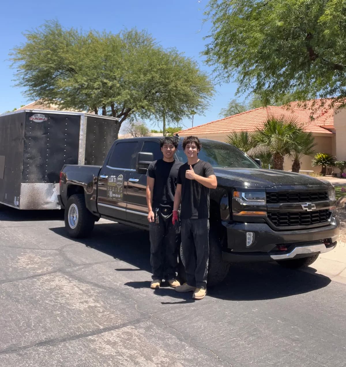 Canyon Haul Co. owners Aiden and Renner in front of their truck and trailer